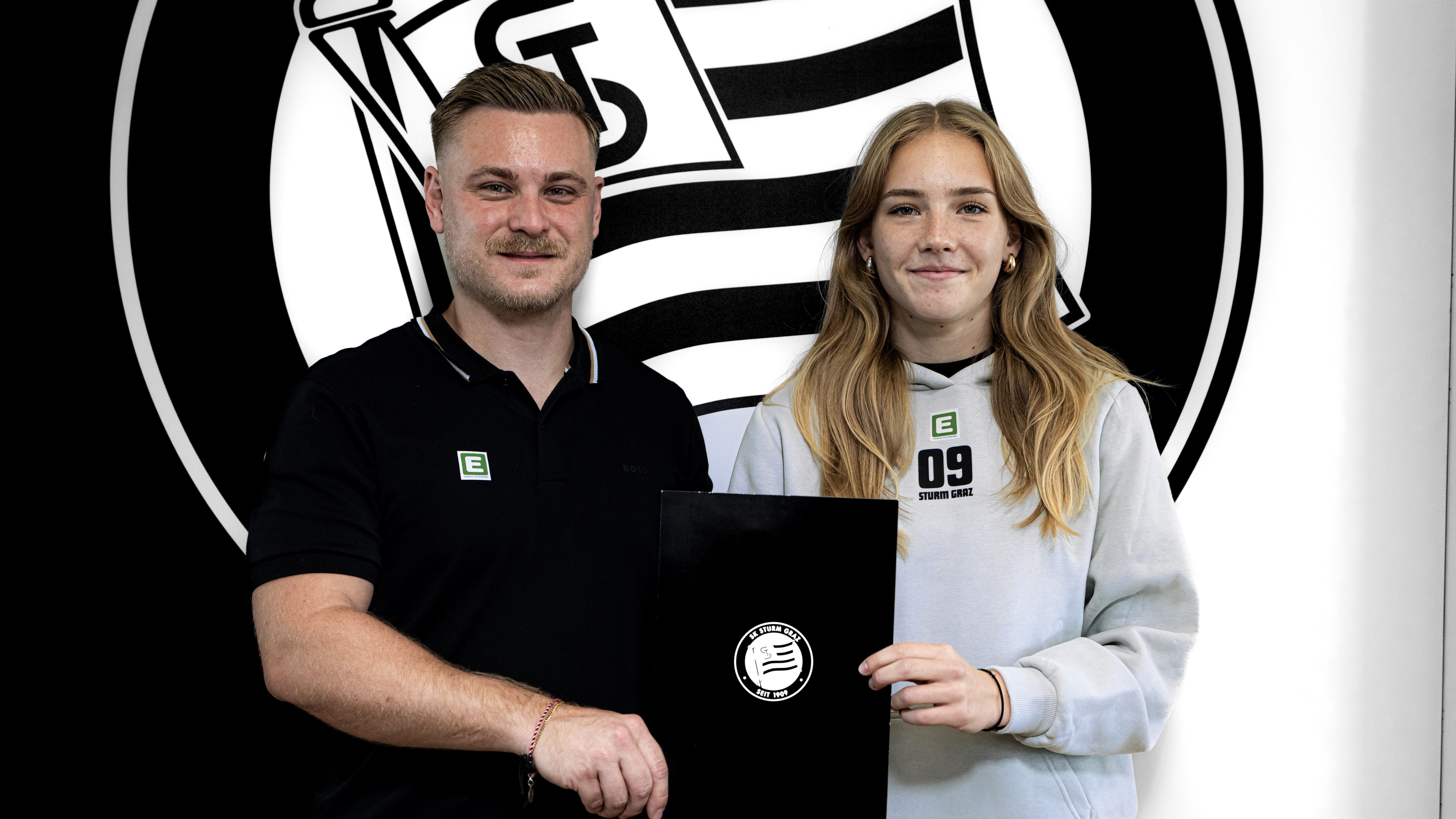 Ein Mann und eine Frau halten einen schwarzen Block hoch