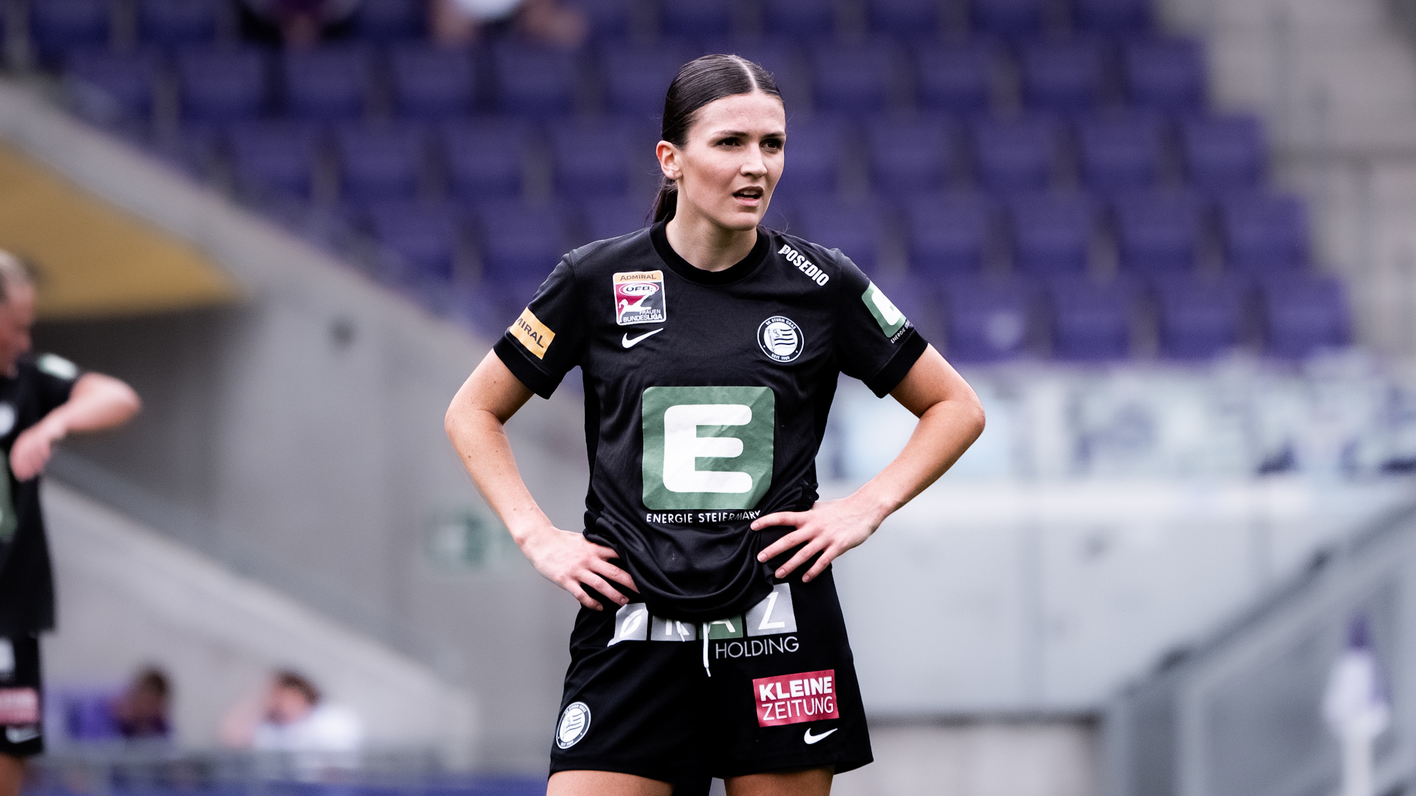 Eine Spielerin in einem schwarzen Trikot schaut traurig in die Ferne.