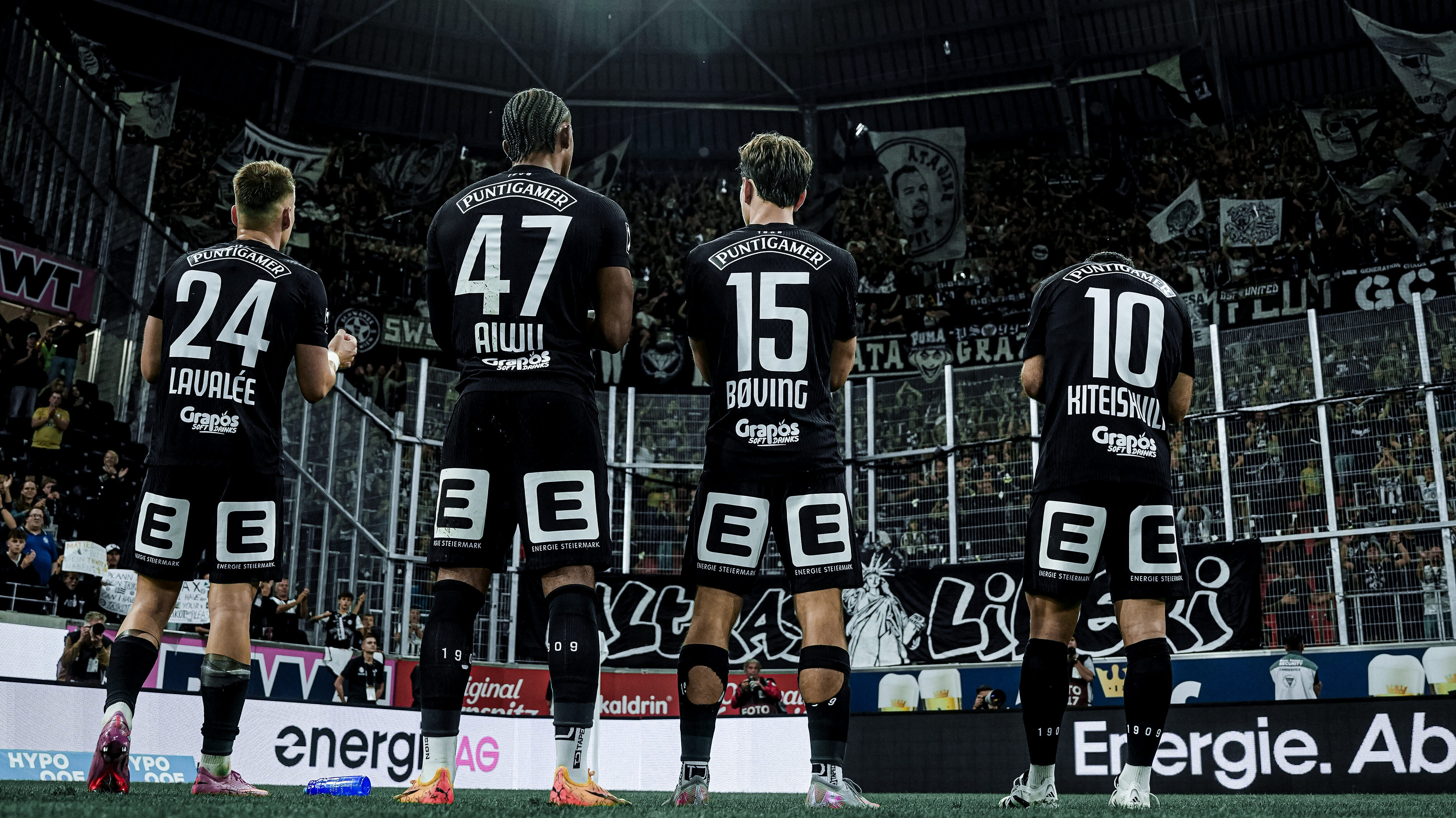 Mehrere Spieler feiern vor Fans.