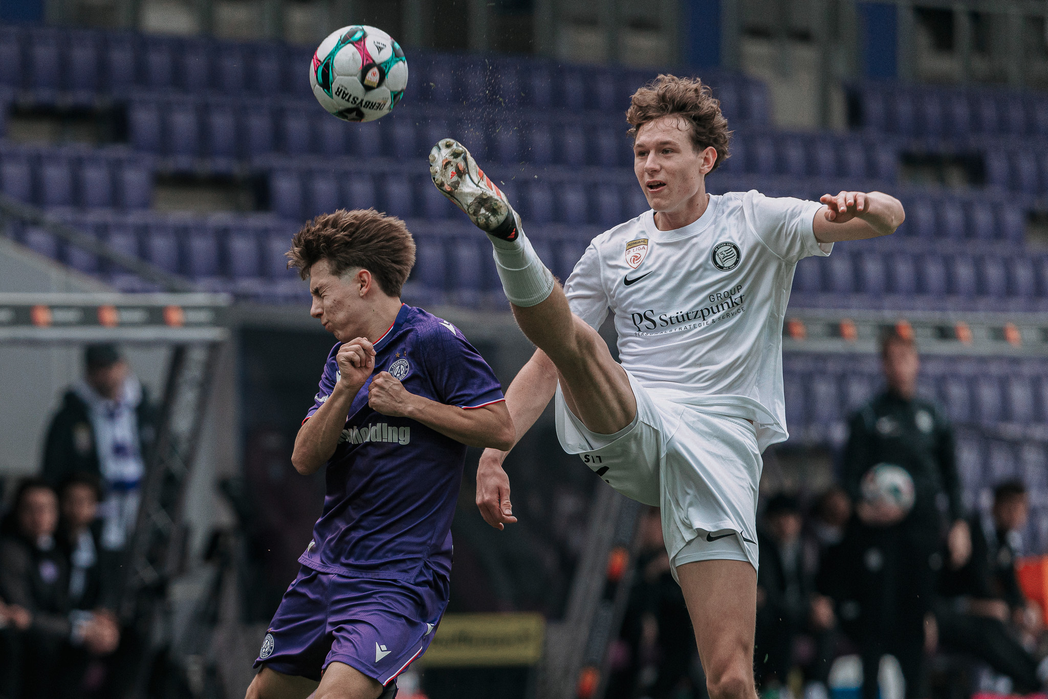 Zwei Männer spielen Fußball.